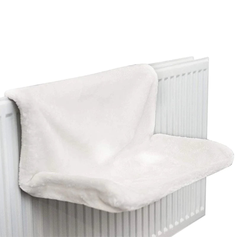 a white couch with a white blanket on top of it 